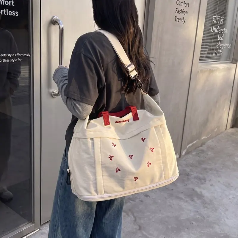 borsa-da-viaggio-nera-in-nylon-per-donne-con-manico-imbottito-verde-e-dettagli-ricamati-borsa-sportiva-da-weekend-a-tracolla