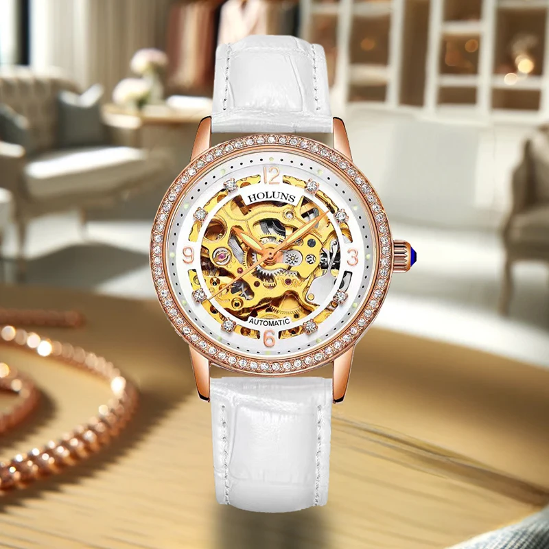 

A women's elegant style mechanical watch with rose gold case, white PU leather strap, and rhinestones