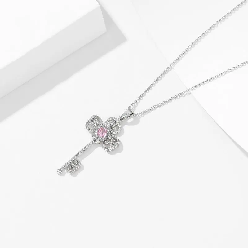 A one-shoulder necklace dress paired with a trendy and high-end designer key collarbone chain