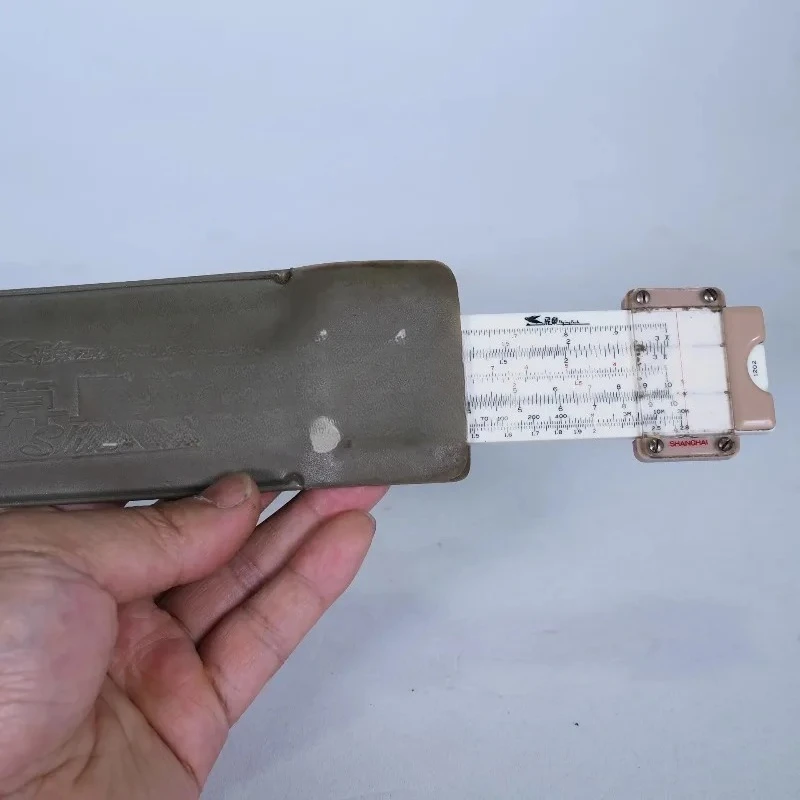 Logarithmic Slide Rule: Nostalgic Old Object, Folklore Ornament & Classic Calculator