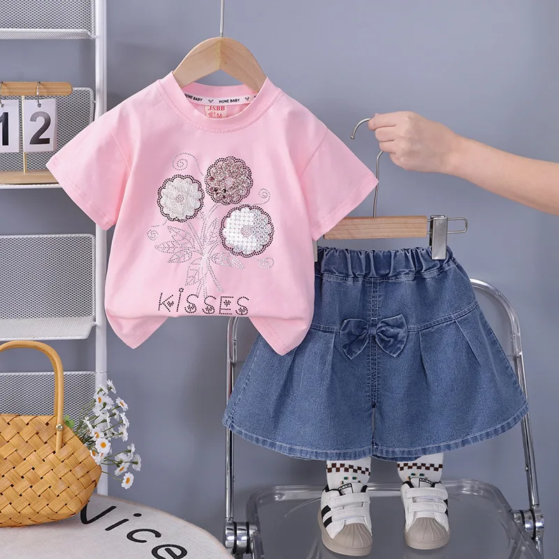 

Новый летний комплект для девочек 2026 года: футболка с пайетками и цветочным принтом и джинсовая юбка-шорты. Модный наряд в стиле милой принцессы для малышей.