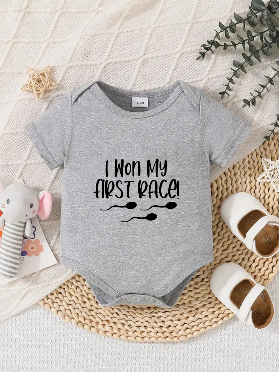 Playful letter-printed baby short-sleeve triangle bodysuit. Button closure for easy dressing