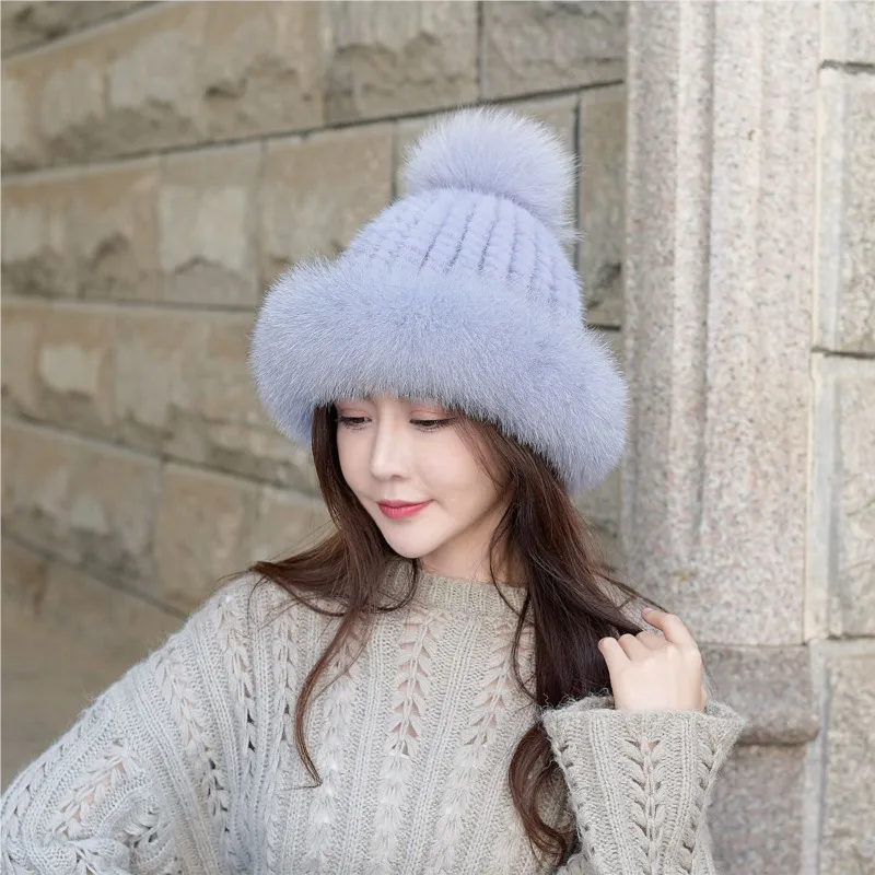 

A new style of woolen knitted fur hat for women paired with pom-pom and ear-protecting leather