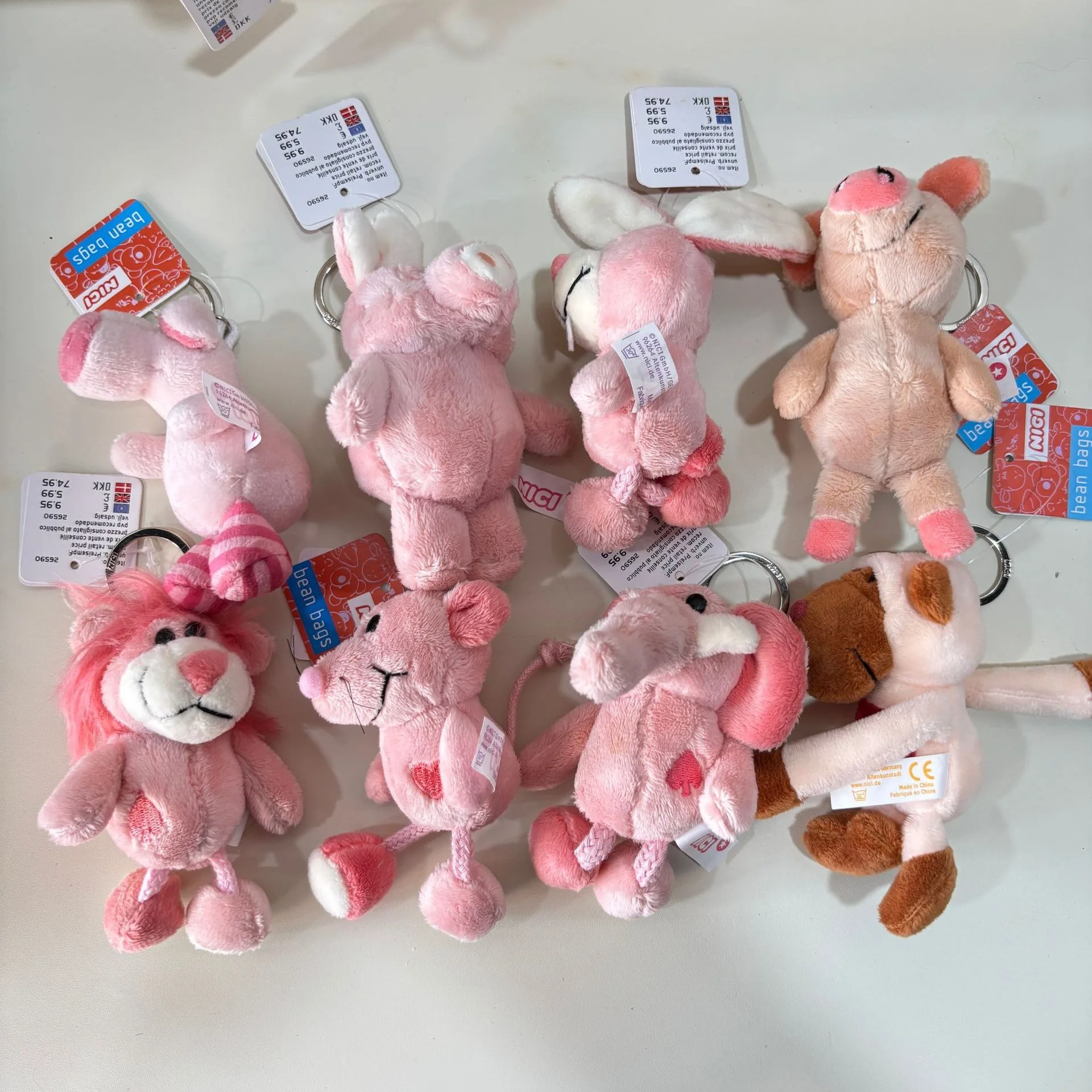 Niedlicher Plüsch-Schlüsselanhänger mit Farbblock-Ara und rosa Löwe – Cartoon-Tier-Stofftier, Taschenanhänger und Accessoire