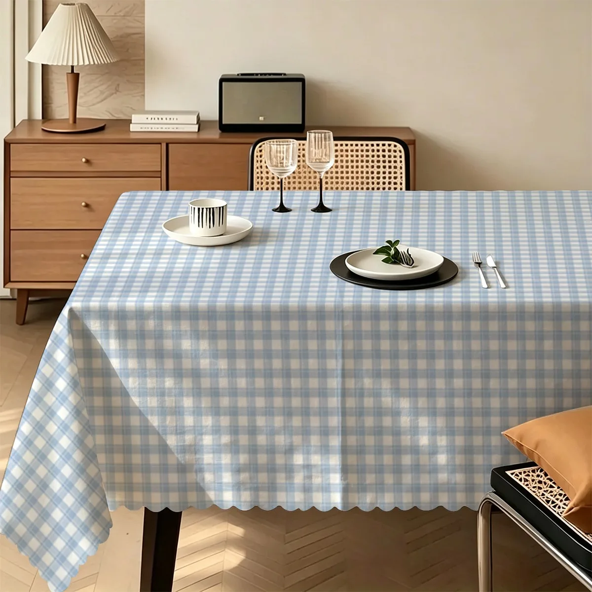 A tablecloth featuring a fine blue and white check pattern combined with overall white ruffled edges as the design.