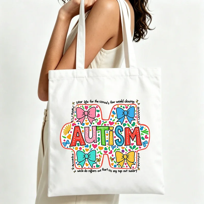 autism awareness graphic canvas tote bag with colorful bow design, perfect for casual daily use and shopping outings