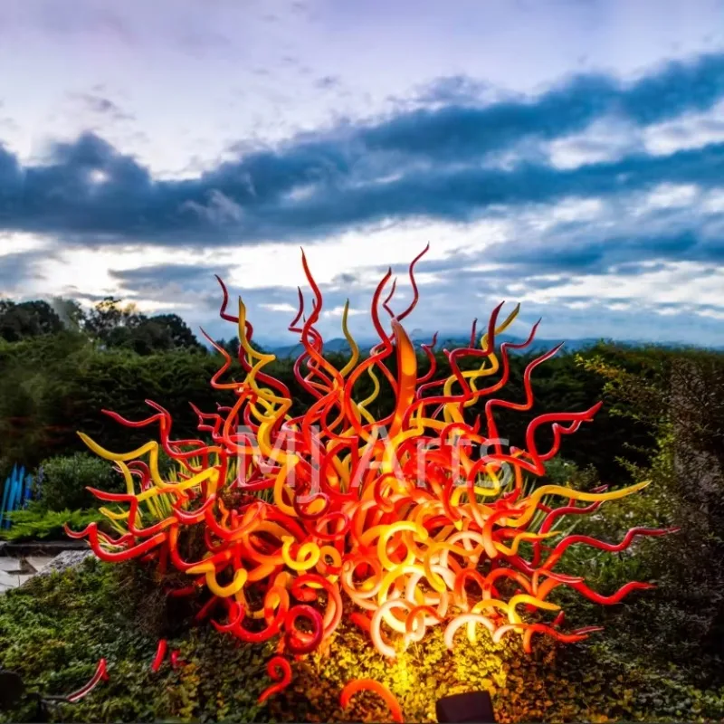 Tall hand-blown glass sculpture, vivid fire red yellow outdoor standing spear nail art, craft and love style home garden