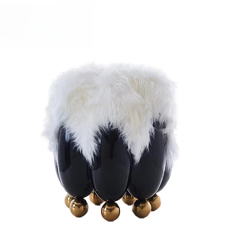 Modern art style glossy black fiberglass decorative stool with rounded profile and golden stainless steel spherical feet