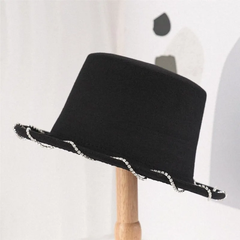 

An elegant black flat-topped top hat with a wavy and unique design in the style of Hepburn