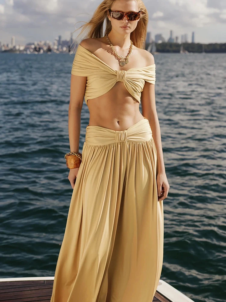 

Sexy off-the-shoulder cropped beach dress, solid color top, pleated midi skirt, vacation style set, new summer 2026.