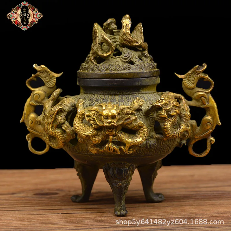 Copper incense burner with gilded nine-dragon design, a decorative piece for display at a street market