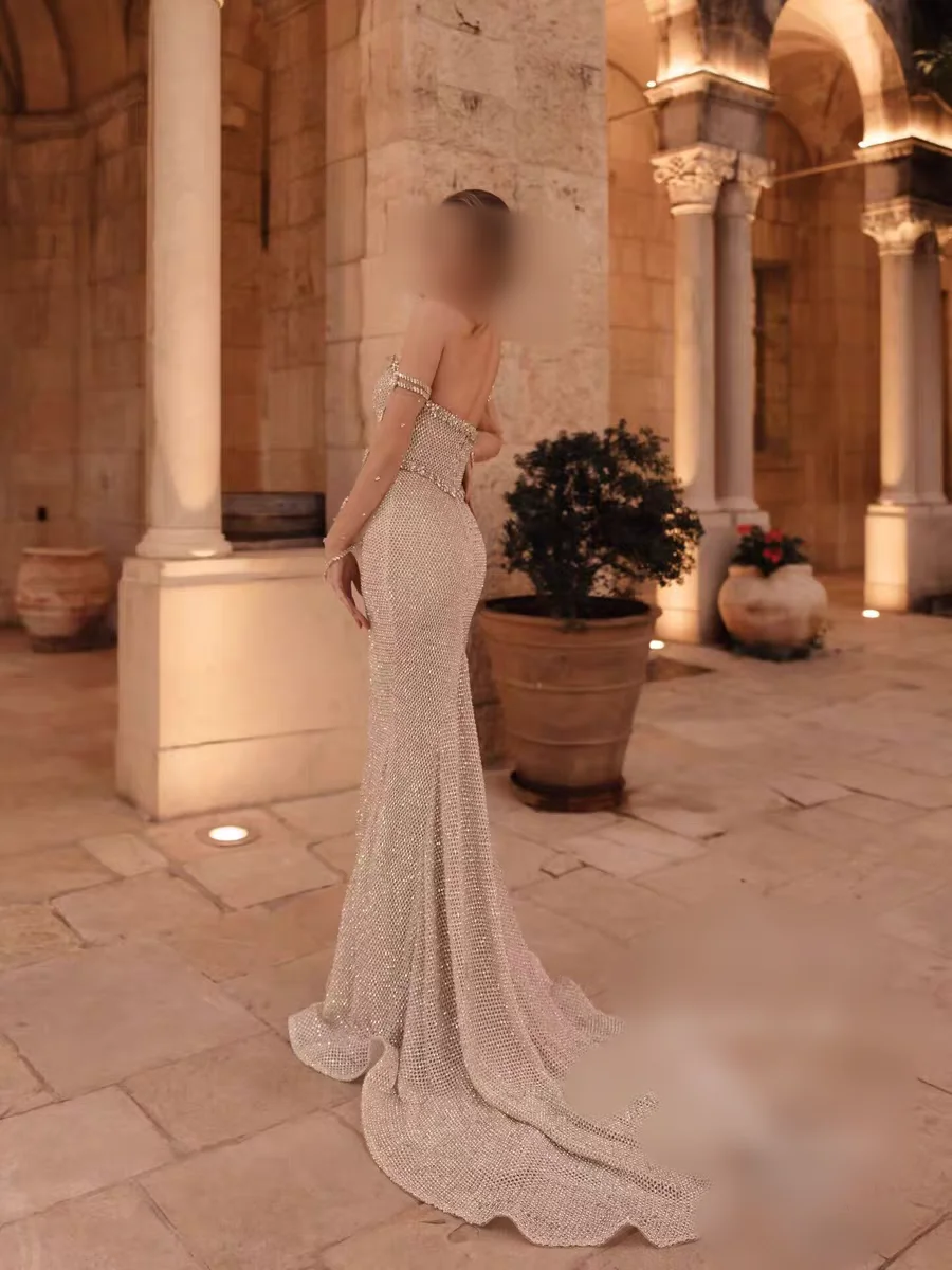 customized evening dress champagne beaded mermaid gown with halter neckline, crystal accents and matching arm cuffs