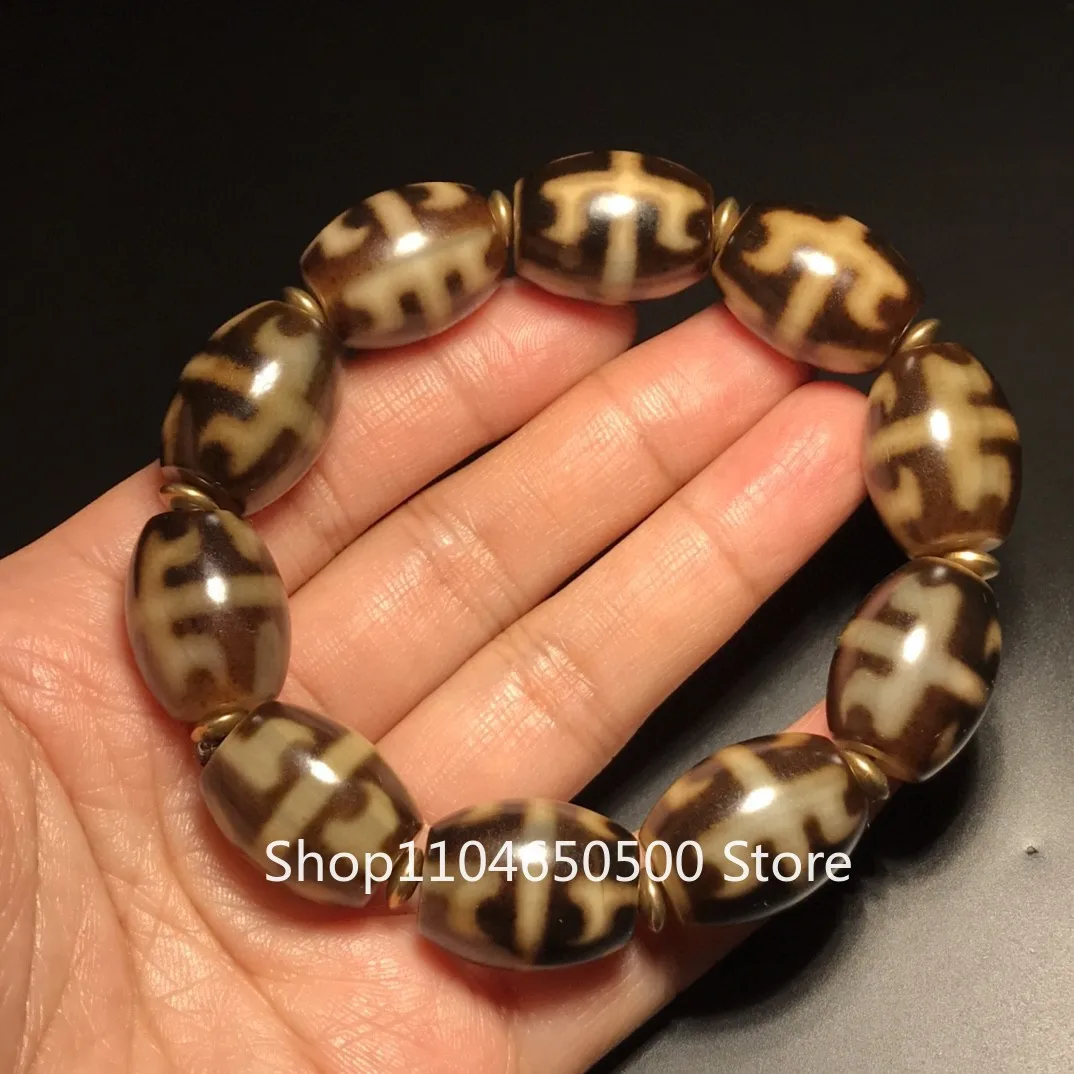 The pulp-coated black and gold old agate unbounded magic tool Dallo dzi bead bracelet bracelet is held in hand, and the old gas