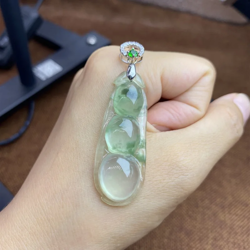 Natural a Ice-like Floating Green Jade Pendant with Green Bean White Background