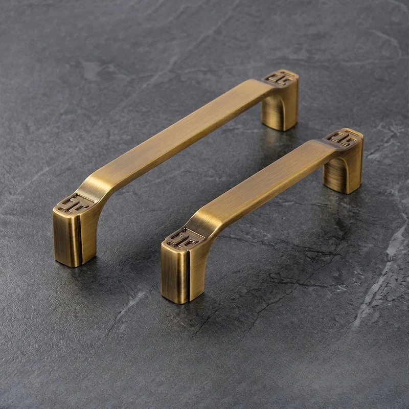 Yellow bronze-colored drawer cabinet door handle furniture accessory with interlaced patterns, antique-style long pull handle.
