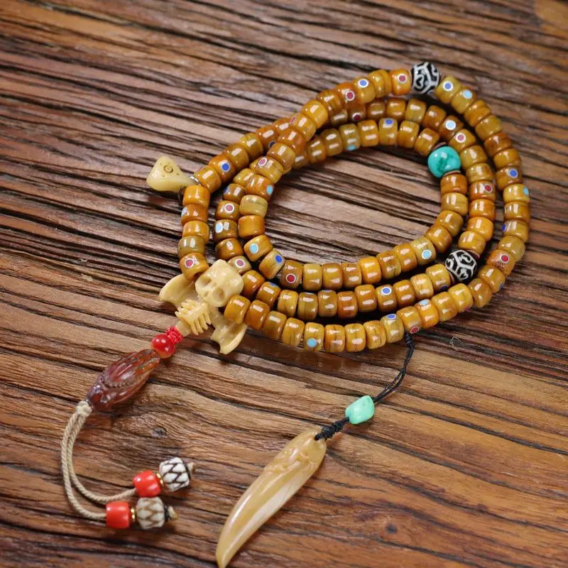 Tibetan bone bead rosary with 108 featuring multi-treasure-style turquoise dzi beads