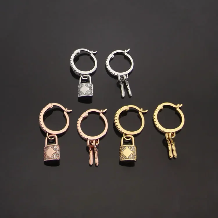 Women's asymmetrical earrings with key locks