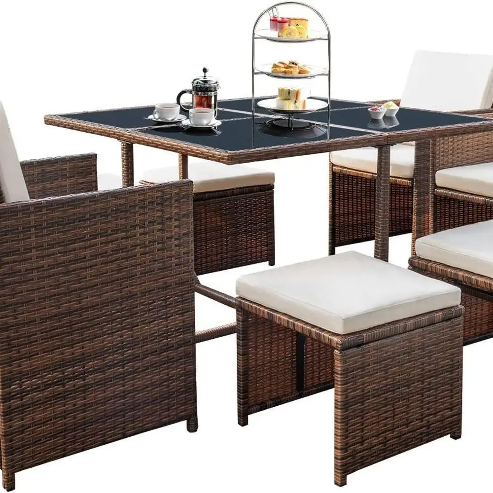 

Space-Saving Outdoor Patio Dining Set with 9 Rattan Chairs, Glass Table, Beige Cushioned Seating, and Sectional Conversation Are
