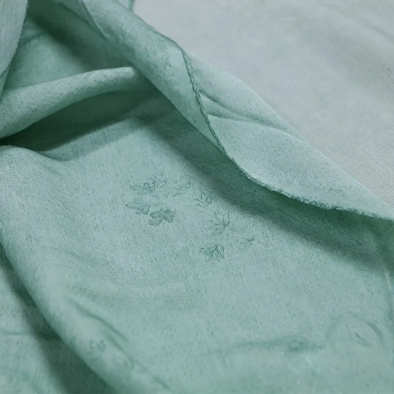 

A new jacquard dirt-dyed fabric made of tussah silk with clear blue and green color from
