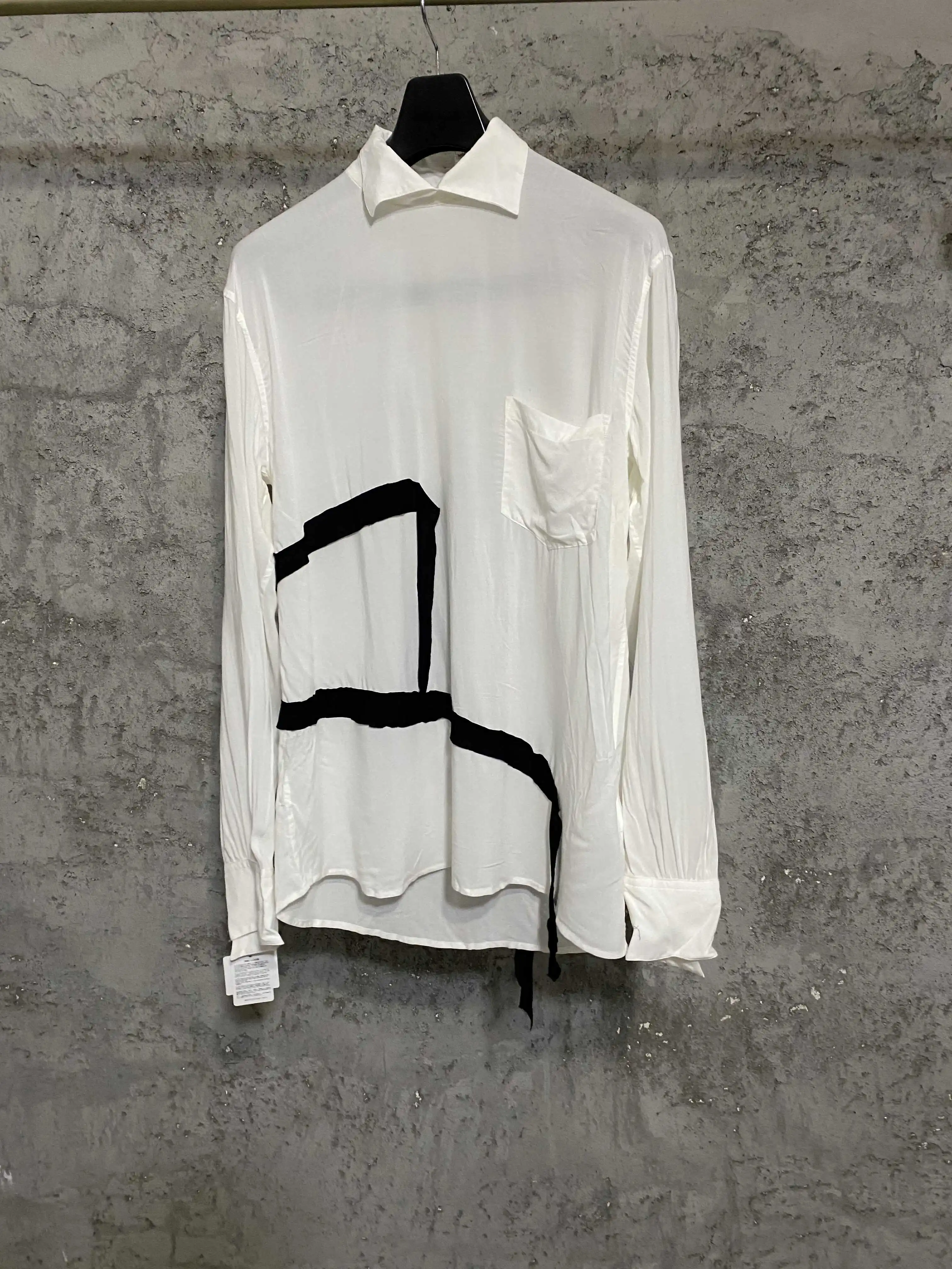 A black and white shirt with a slit ribbon on the back made of Japanese premium fabric