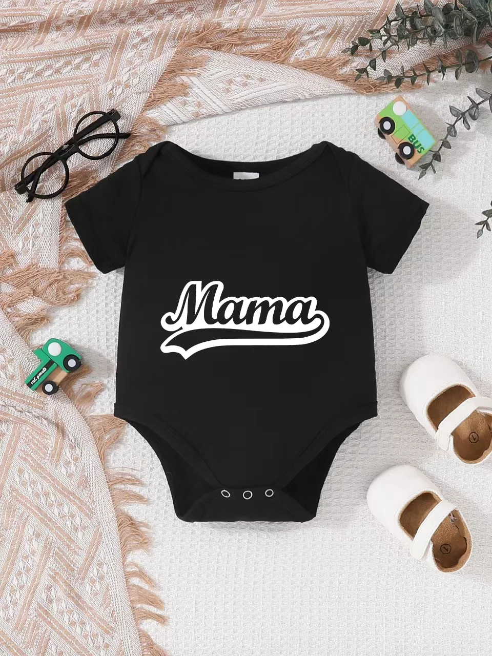 Playful letter-printed baby short-sleeve triangle bodysuit. Button closure for easy dressing