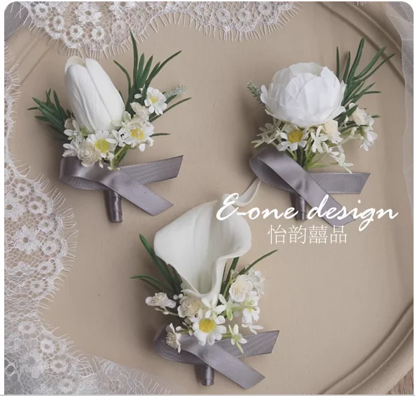 White calla lily tulip wedding corsage wrist flower wedding lapel bride groom groomsman bridesmaid shot.