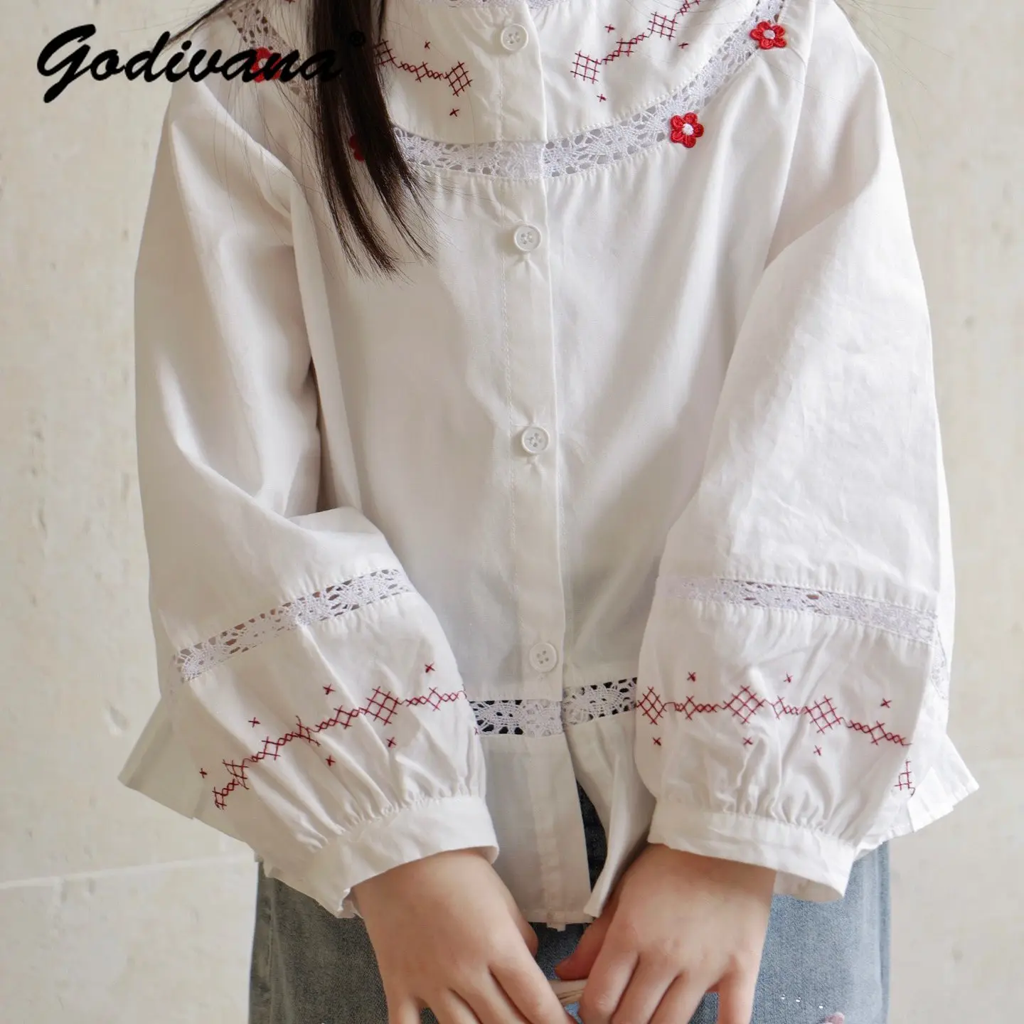 

2026 Spring New Little Girls Japanese White Blouse Kids Soft Pure Cotton Floral Embroidery Lace Neck Puff Sleeve Ruffle Hem Top