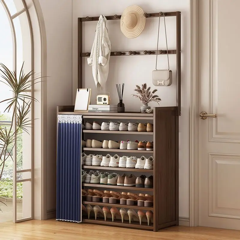 The shoe rack is against wall and at the door of house hanger is integrated into home door rental house