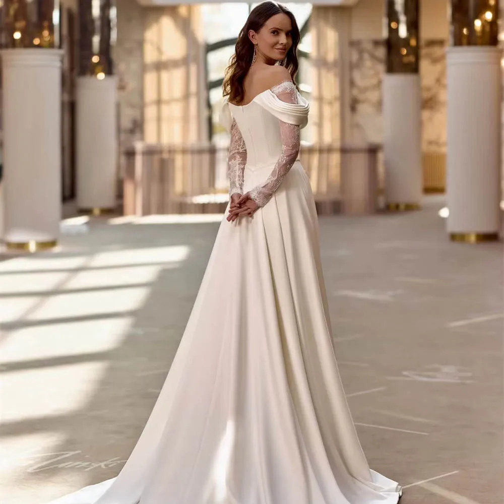 Elegancka suknia ślubna na zamówienie dla panny młodej, satynowa, w stylu boho, z dekoltem w serduszko, długie rękawy, miękka linia A, tren dworski, suknia ślubna typu vestido.