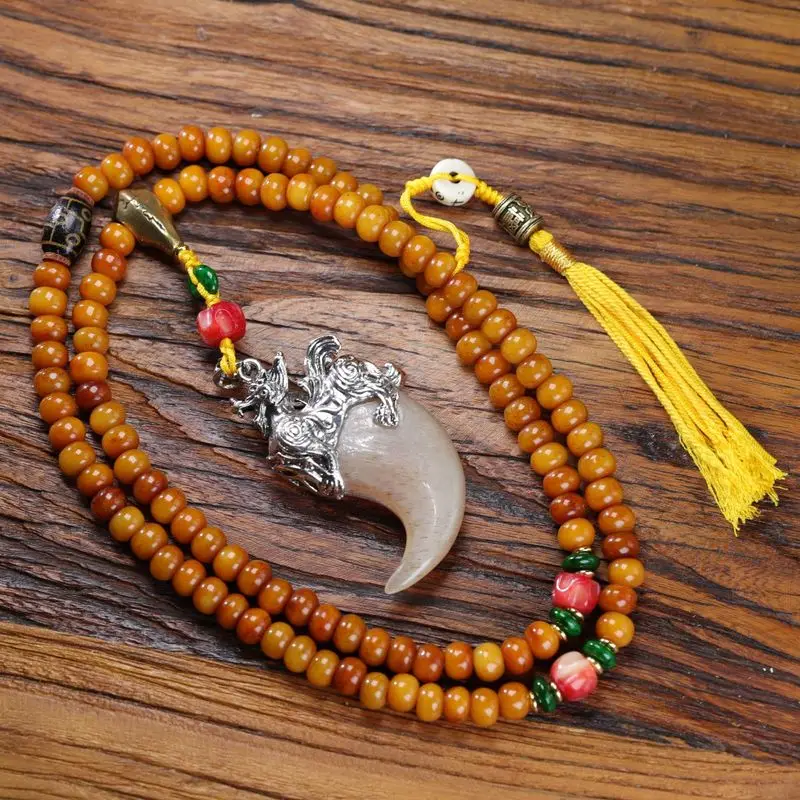 Natural apple bead necklace with a horn-shaped copper pendant and ivory accents