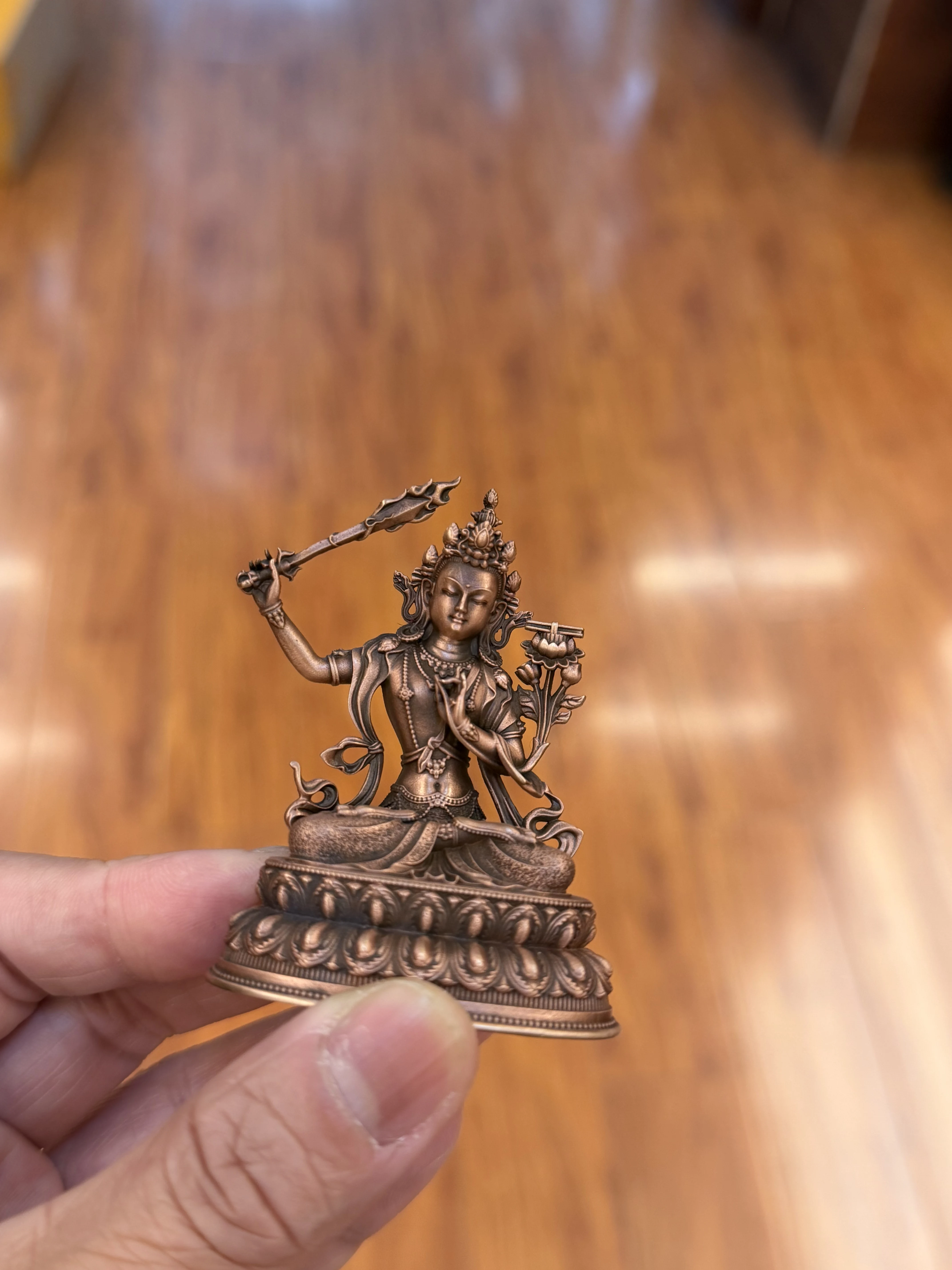 The pure purple bronze statue of Manjushri Bodhisattva stands 6 centimeters tall
