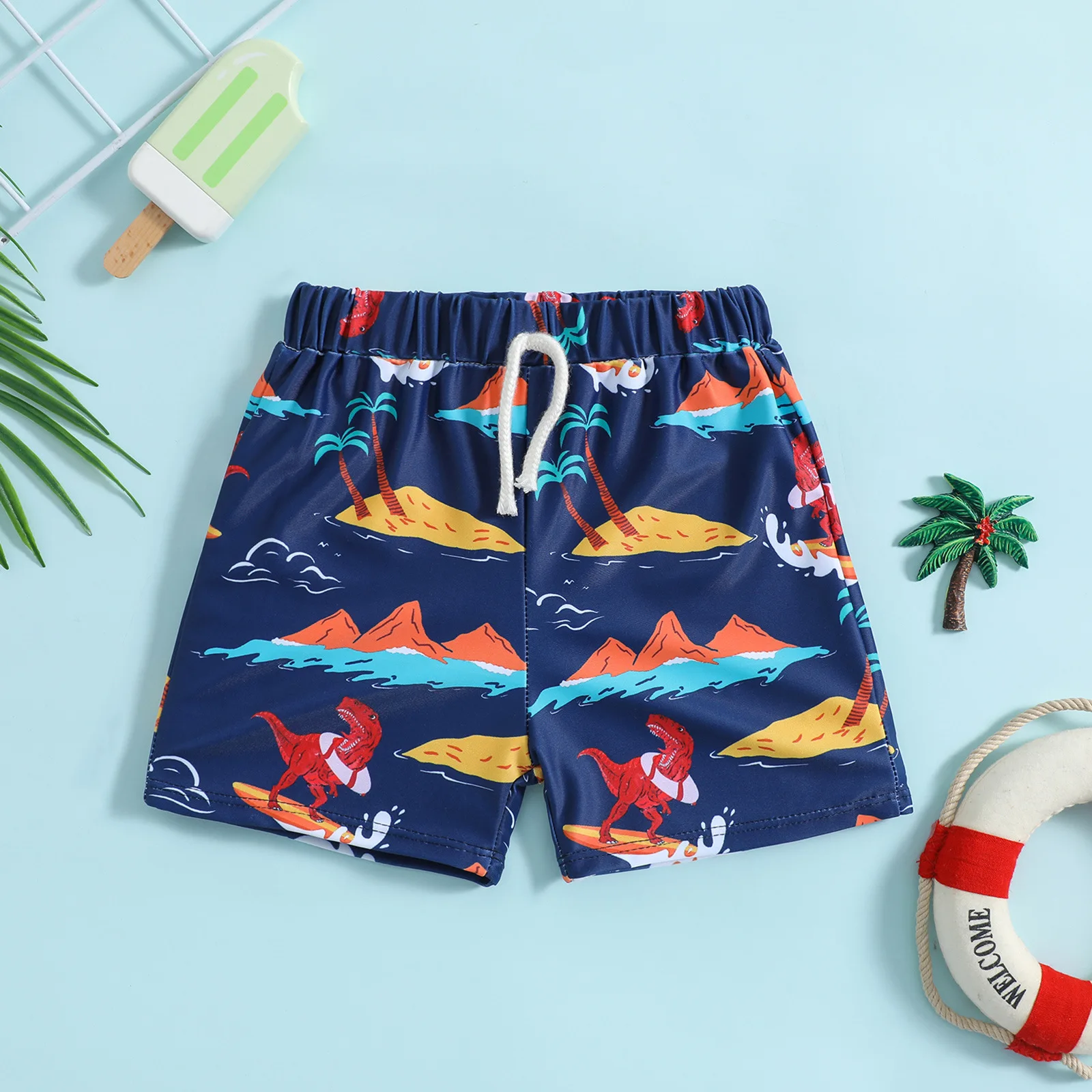 Boys drawstring swim shorts with surfing dinosaur island print suitable for seaside and pool play