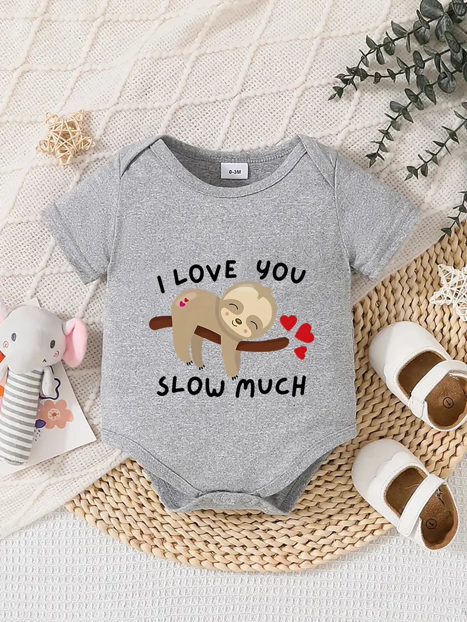 Playful letter-printed baby short-sleeve triangle bodysuit. Button closure for easy dressing