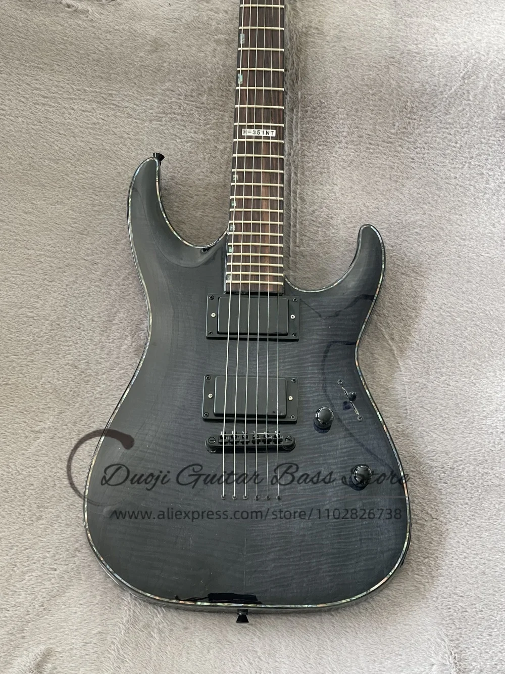 Transparent black guitar, fixed bridge, flamed maple top, maple neck set in solid wood body, abalone binding, HH pickups