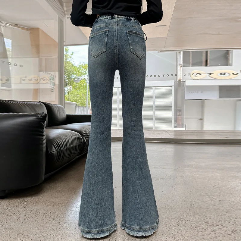 Girls' Slim Fit Jeans in Urban Style with Winter Plush Irregular Hem Flares. High-Waisted Denim for Juvenile Youth.