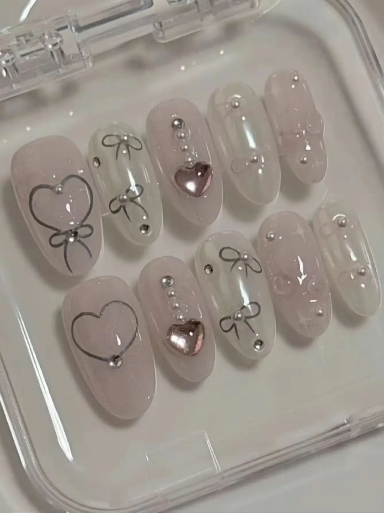 10-Piece Set of Korean-Style Sweet Wearable Nails, Short Oval Shape, Sheer Pink Nude Color, Hand-Painted Heart Bow, Reusable Fake Nails with Metal Heart Beads