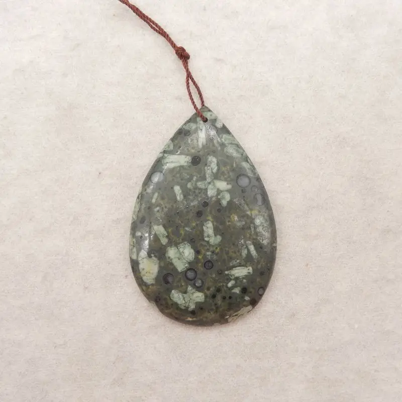 

Handcrafted Plant Stone Teardrop Pendant on Brown Cord, Natural Speckled Green Gemstone, Boho and Earthy Jewelry Designs