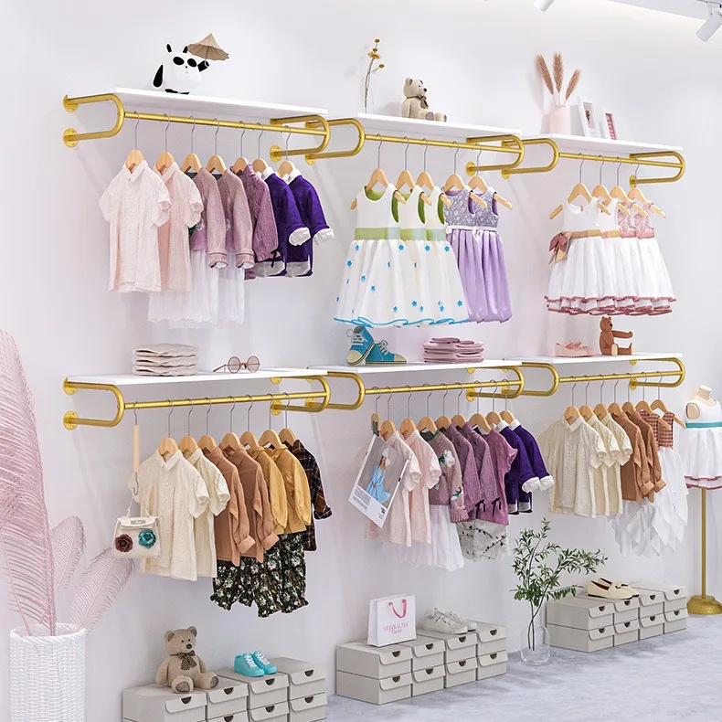 

Children's clothing store display rack Wall-mounted gold shelf Wall display rack Children's clothing store hanger combination