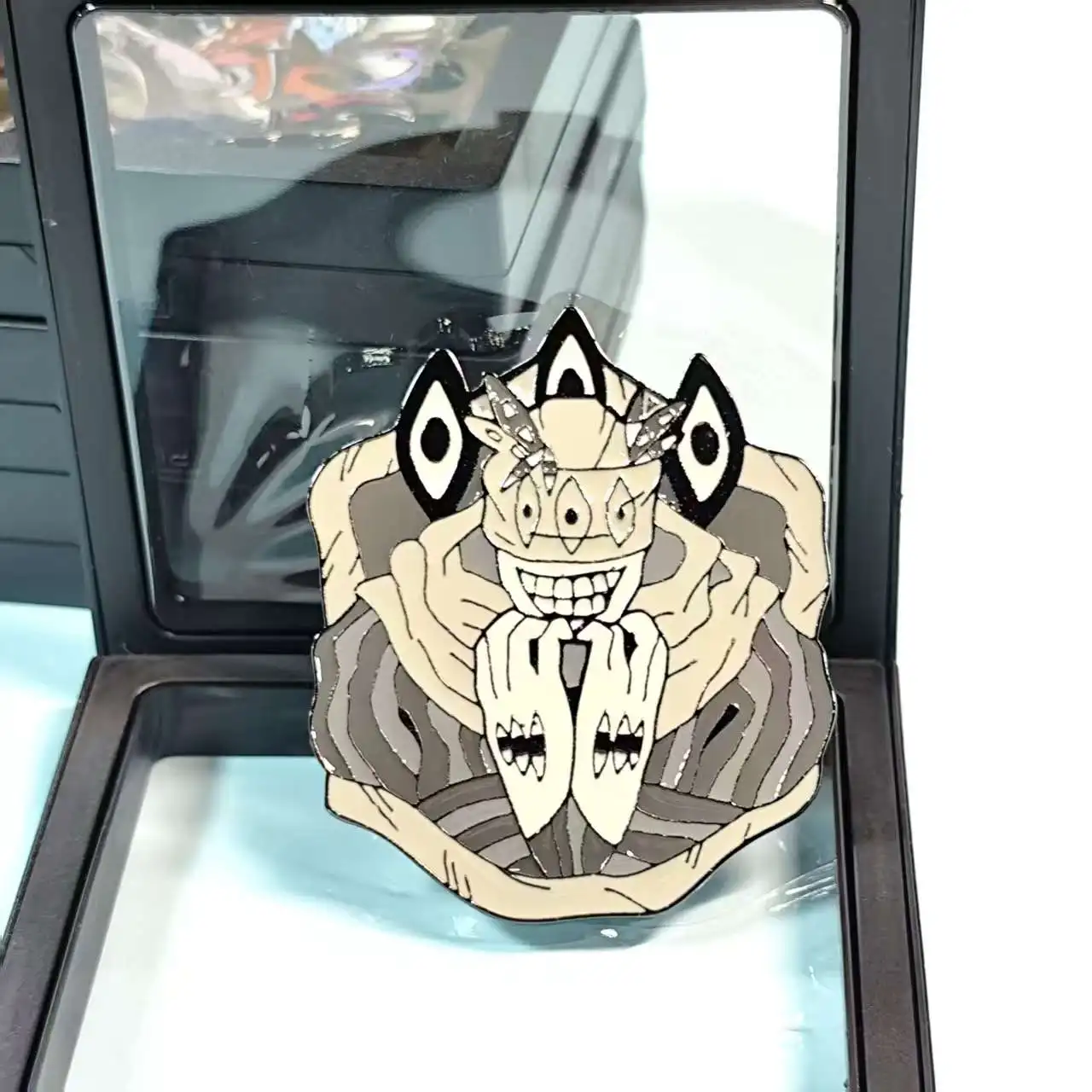 Anime - inspired enamel pin with a strange character. Cool collectible for fans, easy to pin on items.