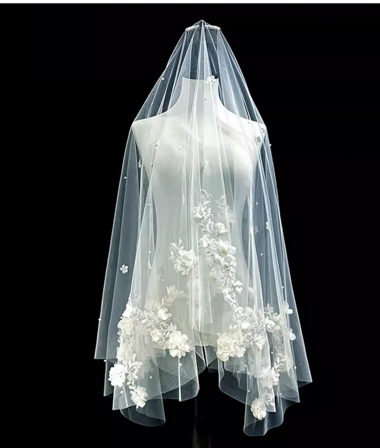 The bride's wedding veil is an ethereal, forest-inspired lace and floral design, perfect for wedding registration and photoshoot