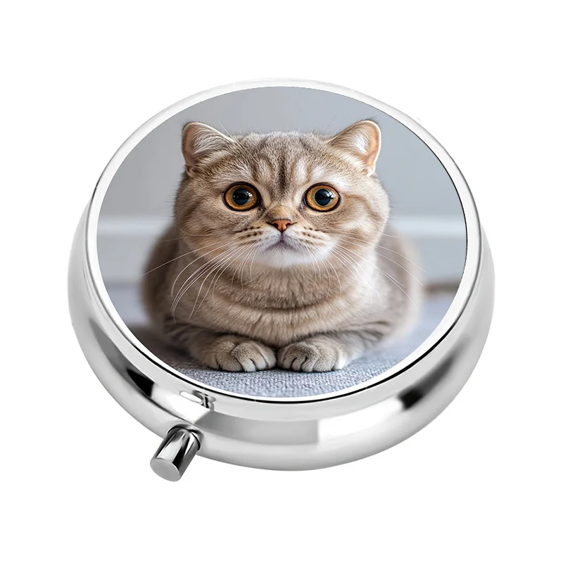 A cute cat-designed mini travel pill box with three compartments, suitable for storing medication and vitamins in a decorative metal container, 1 piece.