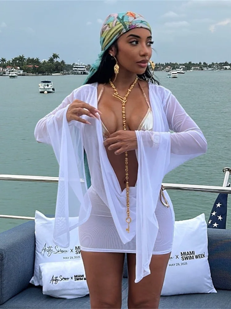 Sukienka Nibber z kołnierzykiem, rozkloszowanymi rękawami, odkrytymi plecami, sznurowaniem, frędzlami, zakładkami, siateczką, seksowna, idealna na plażę, imprezę, w stylu kokieteryjnym, mini, dopasowana.