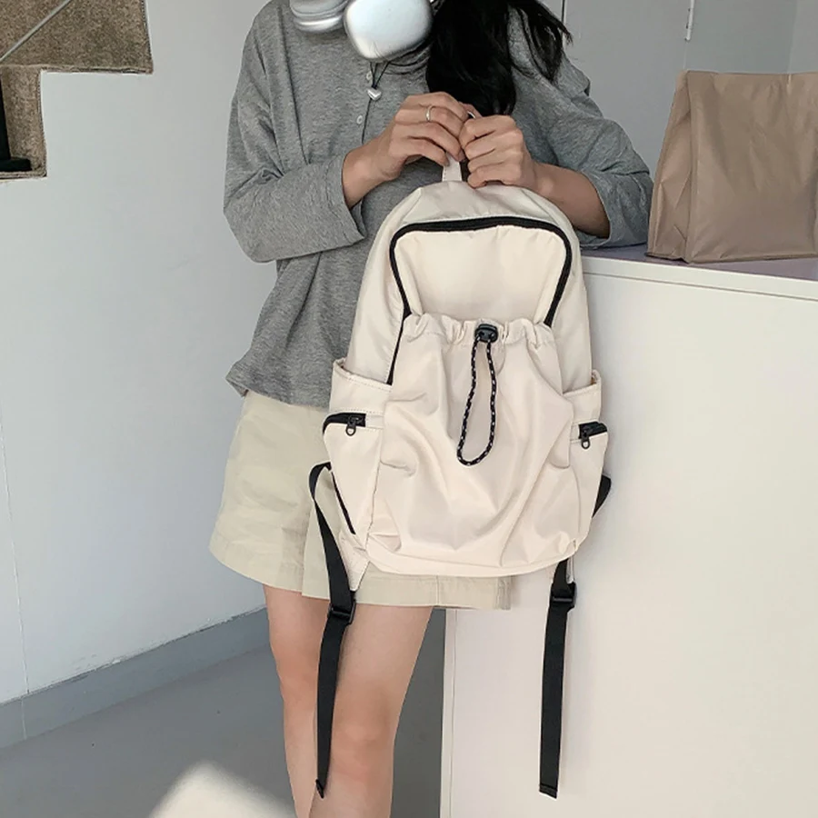 Mochila Coreana de gran capacidad para niñas, bolso de hombro plisado de nailon, mochila de viaje de color sólido, mochila negra