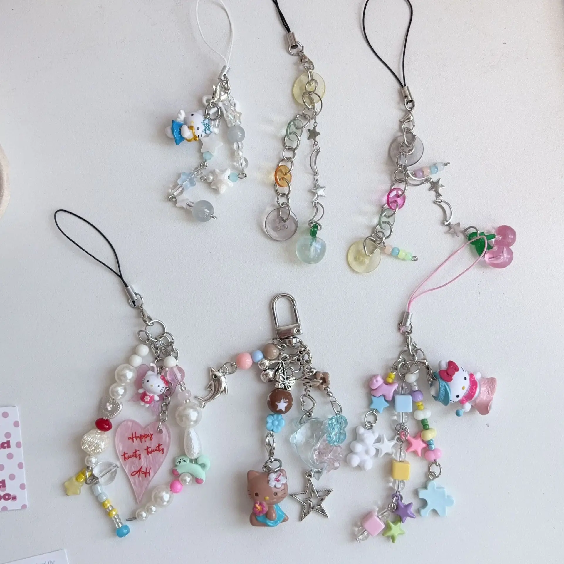 ซานริโอ เฮลโล คิตตี้ ลิตเติ้ล ดอลฟิน หนังสีดำ สายคล้องโทรศัพท์แบบทำมือประดับลูกปัด สายคล้องกระเป๋า สายคล้องกล้อง ของขวัญวันเกิดสำหรับเด็กผู้หญิง