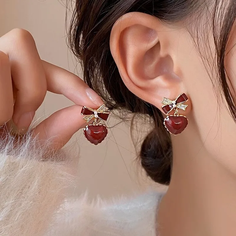 Affordable promotion bow peach heart earrings for women, niche, mature, stable temperament, red ear buckle
