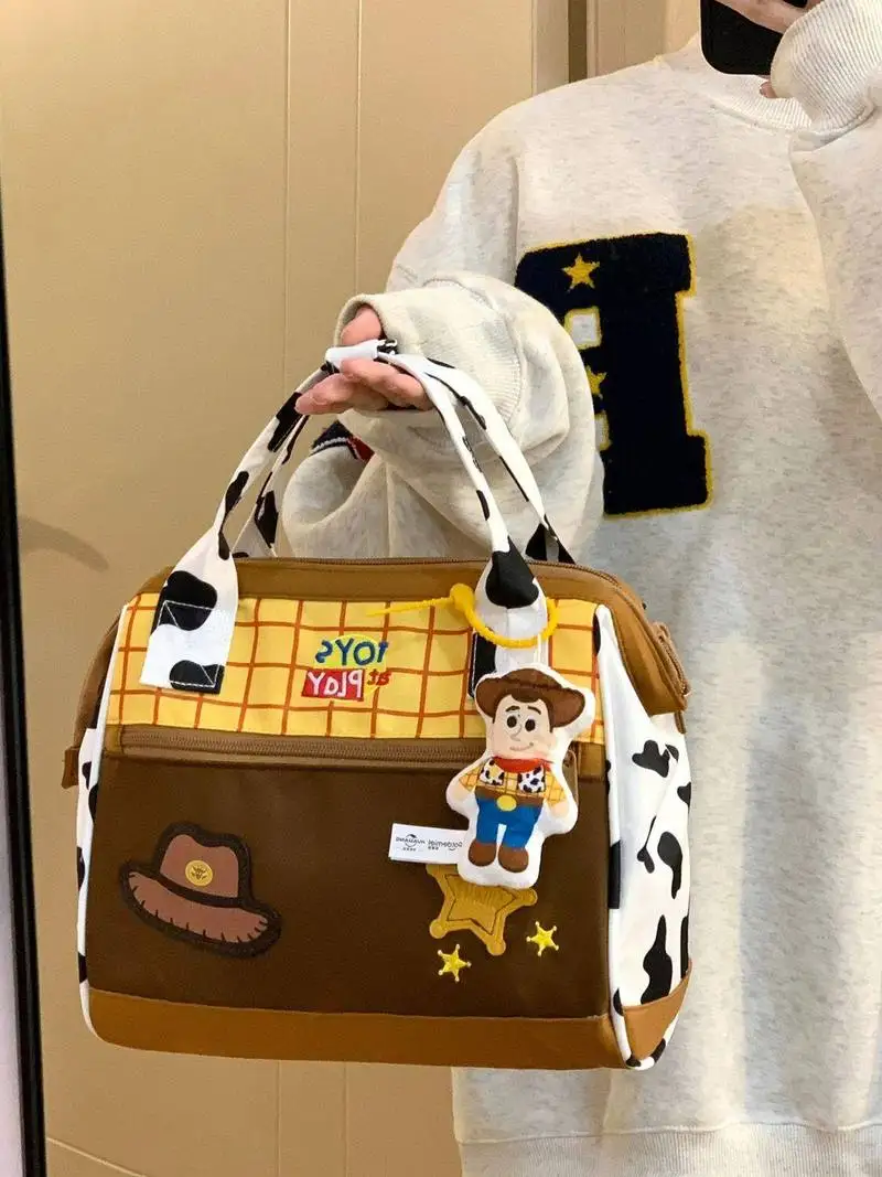 

Toy Story Woody Tote Crossbody Bag Women 2025 New Large Capacity Cow Print With Woody Pendant For Outdoor Travel Daily