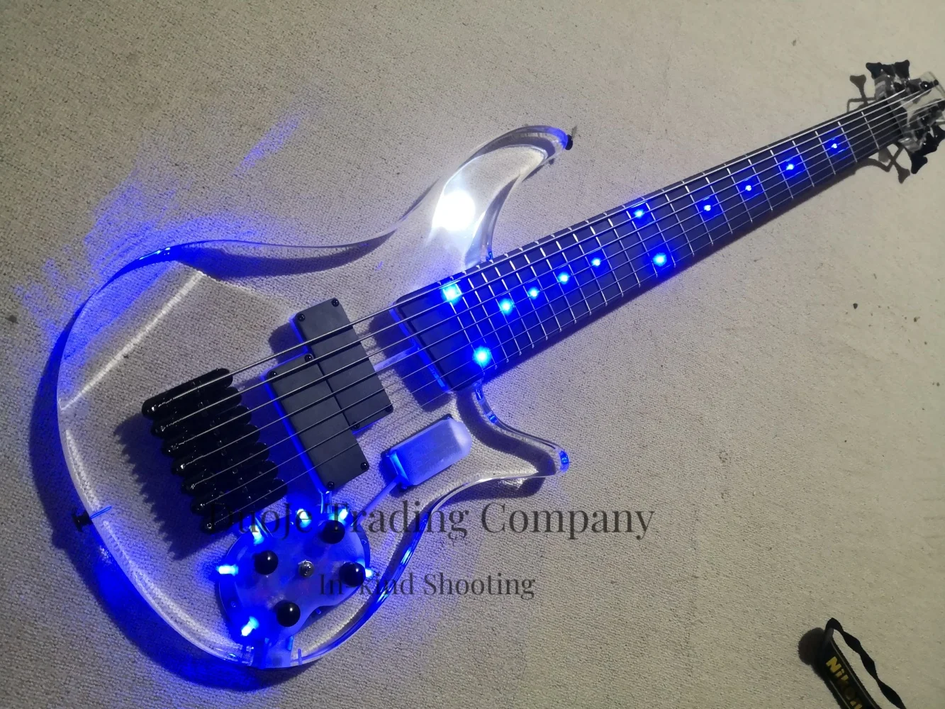 7 string crystal bass guitar, fixed bridge, acrylic body, rosewood fingerboard, acrylic headstock, blue LED lights