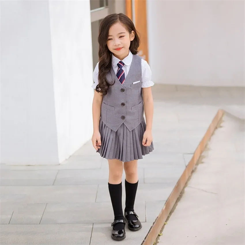 Uniforme scolastica coreana per bambini Ragazzi Ragazze Gonna a pieghe Canottiera Top Set di abbigliamento per prestazioni per bambini Abbigliamento da palcoscenico Uniforme da studente
