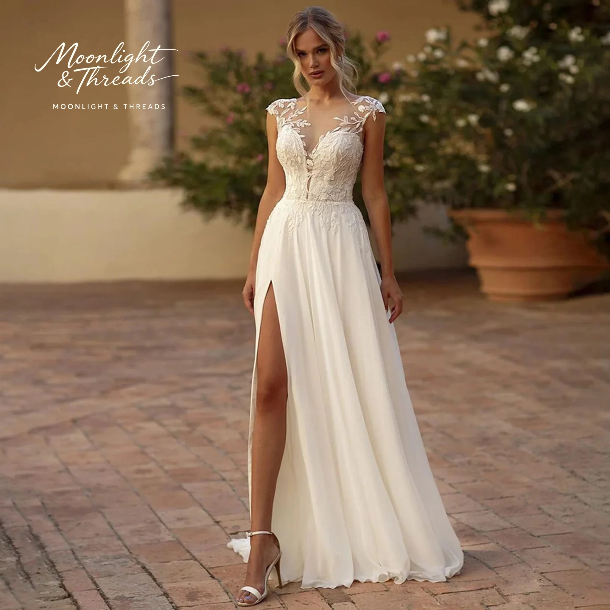

White off-the-shoulder strapless formal gown featuring lace embroidery cut-out details and a slit hem perfect for weddings
