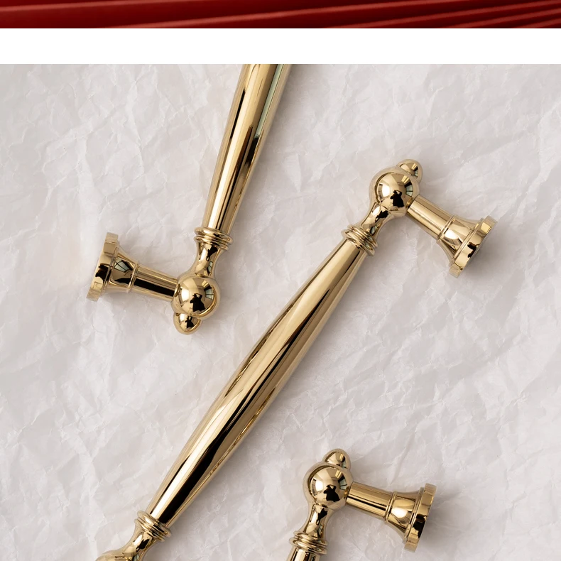Pair of gold brass handles showing tapered central bars